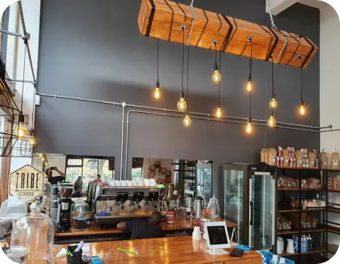Tribe Coffee interior with barista working at the espresso bar