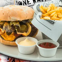 Cheeseburger with jalapeños and melted cheese, fries, ketchup and mayo