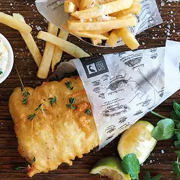 Battered fish and fries with lemon wedge and tartar sauce